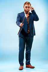 Image showing The barded man in a suit holding cane.