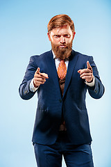 Image showing Portrait of a business man isolated on blue background.