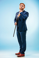 Image showing The barded man in a suit holding cane.