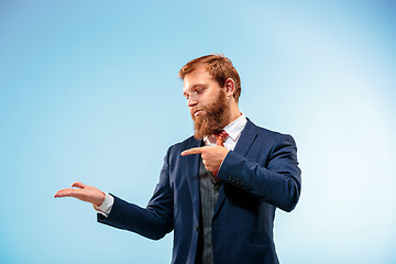 Image showing Portrait of a business man isolated on blue background.