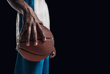 Image showing The hand of a basketball player with ball