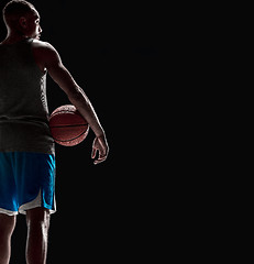 Image showing The hand of a basketball player with ball