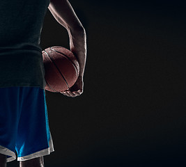 Image showing The hand of a basketball player with ball