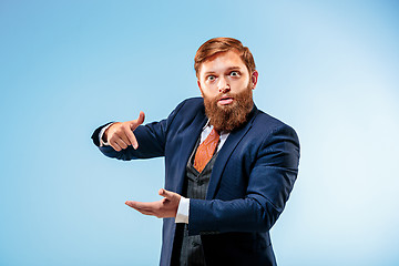 Image showing Portrait of a business man isolated on blue background.