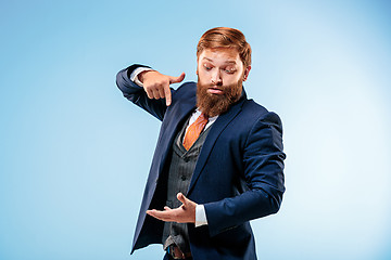 Image showing Portrait of a business man isolated on blue background.