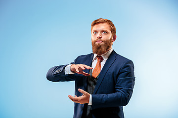 Image showing Portrait of a business man isolated on blue background.