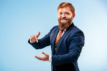 Image showing Portrait of a business man isolated on blue background.