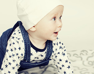 Image showing little cute baby toddler on carpet isolated close up smiling ado