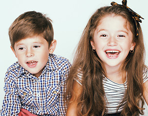 Image showing little cute boy and girl hugging playing on white background, ha