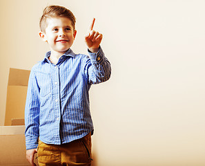 Image showing little cute boy in empty room, remoove to new house. home alone,