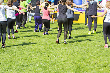 Image showing Group of young girls exercising fitness with dancing in the city