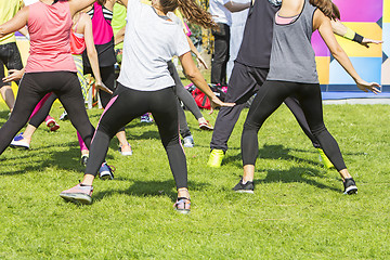 Image showing Group of young girls exercising fitness with dancing in the city