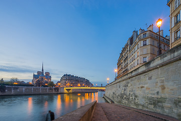 Image showing Notre Dame Cathedral with Paris cityscape at dus