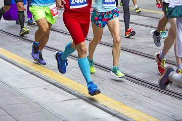 Image showing Marathon runners race in city streets, blurred motion