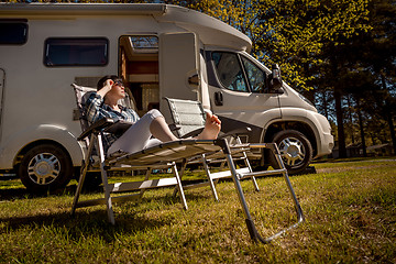 Image showing Woman resting near motorhomes in nature. Family vacation travel,