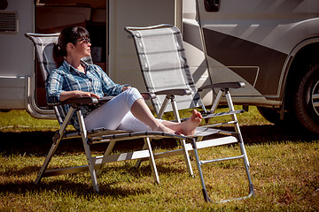 Image showing Woman resting near motorhomes in nature. Family vacation travel,