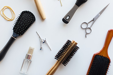 Image showing scissors, hair brushes, clips and styling spray