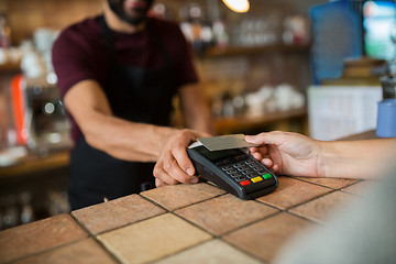 Image showing hands with payment terminal and credit card