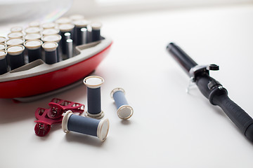 Image showing hot rollers kit on table with hair clips and iron