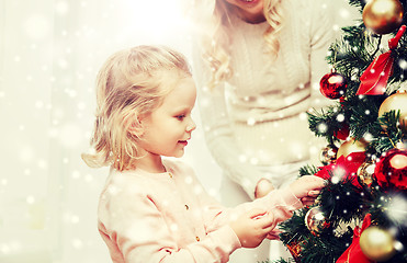 Image showing happy family decorating christmas tree at home