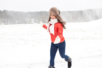 Image showing happy woman in winter fur hat having fun outdoors