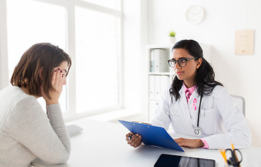 Image showing doctor with pink awareness ribbon and sad patient