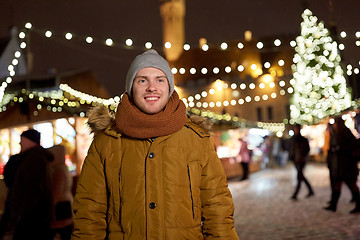 Image showing happy young man at christmas market in winter