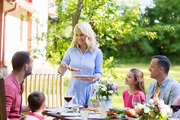 Image showing happy family having dinner or summer garden party