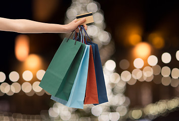 Image showing shopping bags and credit card in hand at christmas