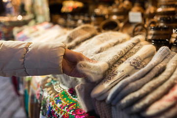 Image showing woman buying woolen mittens at christmas market