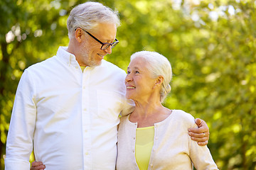 Image showing happy senior couple hugging at summer park