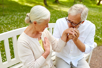 Image showing happy senior couple hugging in city park