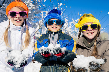 Image showing Happy little children playing  in winter snow day.