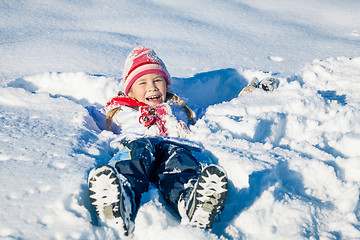 Image showing Happy little girl playing  on winter snow day.