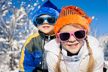 Image showing Happy little children playing  in winter snow day.