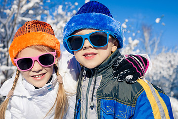 Image showing Happy little children playing  in winter snow day.