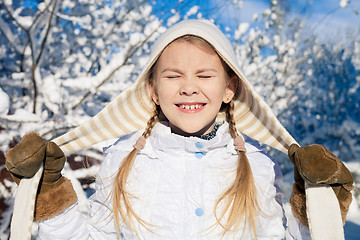 Image showing Happy little girl playing  on winter snow day.