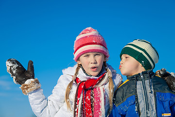 Image showing Happy little children playing  in winter snow day.