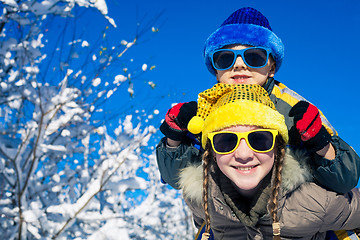 Image showing Happy little children playing  in winter snow day.