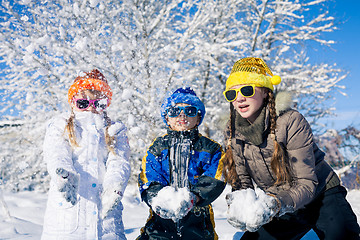 Image showing Happy little children playing  in winter snow day.