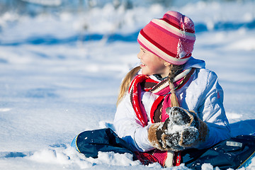 Image showing Happy little girl playing  on winter snow day.