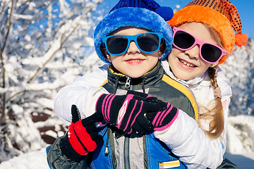 Image showing Happy little children playing  in winter snow day.