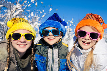 Image showing Happy little children playing  in winter snow day.