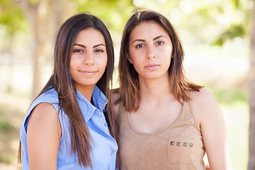 Image showing Two Beautiful Ethnic Twin Sisters Portrait Outdoors.