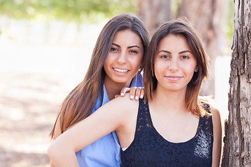 Image showing Two Beautiful Ethnic Twin Sisters Portrait Outdoors.