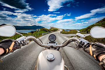 Image showing Biker rides a road with Atlantic Ocean Road in Norway. First-per