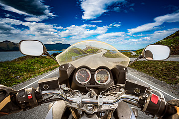 Image showing Biker rides a road with Atlantic Ocean Road in Norway. First-per