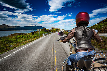 Image showing Biker girl rides a mountain road in Norway Atlantic Ocean Road. 