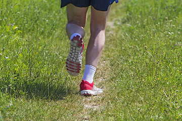 Image showing Young athlete running marathon outdoors