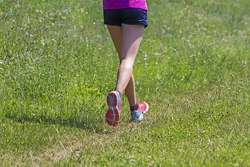 Image showing Young Woman running marathon outdoors